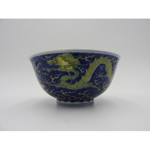 24 - UNDERGLAZE-BLUE AND YELLOW ENAMEL 'DRAGON' BOWLKANGXI SIX CHARACTER MARK AND OF THE PERIODpainted wi... 