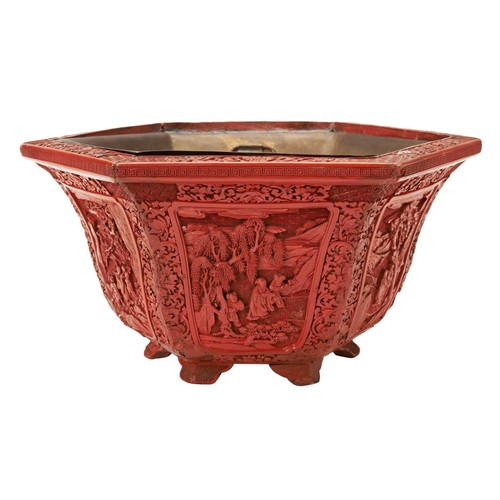 193 - FINE CARVED CINNABAR LACQUER HEXAGONAL JARDINIEREQIANLONG PERIODthe rim carved with lotus flowers an... 