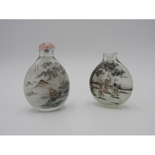 323 - TWO REVERSE GLASS SNUFF BOTTLES20TH CENTURYeach finely painted in reverse, one with boys playing, th... 