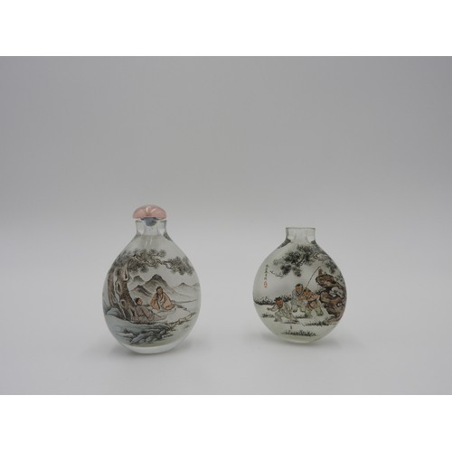 323 - TWO REVERSE GLASS SNUFF BOTTLES20TH CENTURYeach finely painted in reverse, one with boys playing, th... 