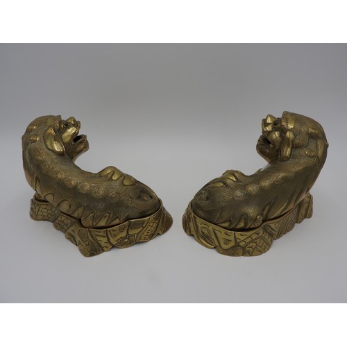 267 - PAIR OF GILT BRONZE BUDDHIST LIONSQING DYNASTY, 19TH CENTURYthe recumbent male and female beasts rai... 