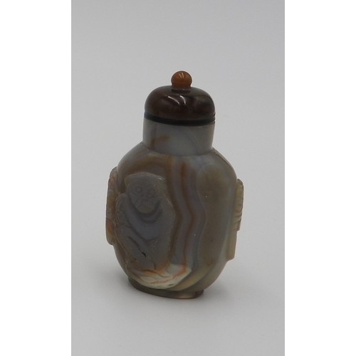 296 - CARVED AGATE SNUFF BOTTLE AND STOPPERQING DYNASTY, 19TH CENTURYthe sides carved a monkey, birds and ... 