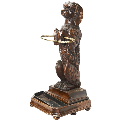 109 - A GOOD 19TH CENTURY BLACK FOREST BRASS-MOUNTED LINDEN WOOD STICK STAND in the form of a begging dog ... 