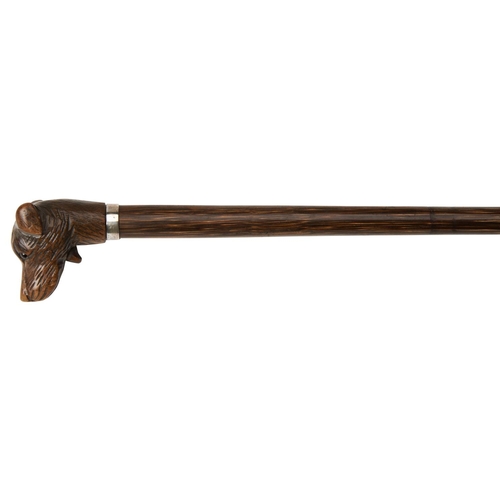 67 - A WALKING STICK with a knop carved in the form of a terriers head, with glass eyes and a white metal... 