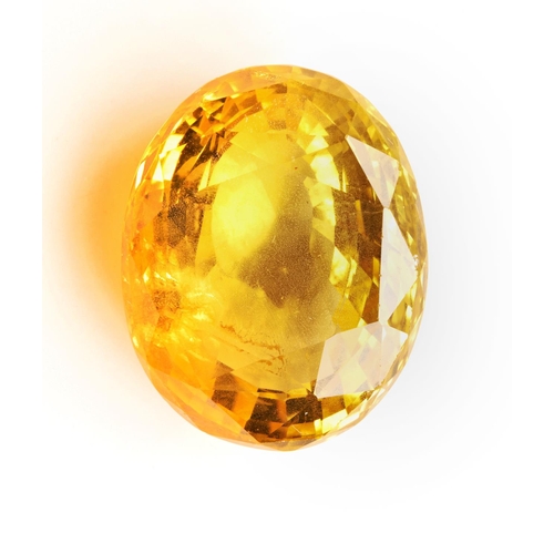 239 - A LOOSE YELLOW SAPPHIREthe oval cut yellow sapphire, stated to weigh 27.96 carats, not tested for tr... 