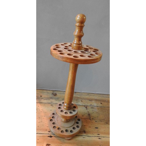 70 - A 20TH CENTURY WOODEN CIRCULAR WALKING STICK STAND with two concentric sets of holes87 cm high... 