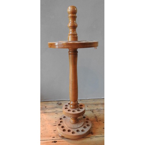 70 - A 20TH CENTURY WOODEN CIRCULAR WALKING STICK STAND with two concentric sets of holes87 cm high... 