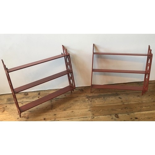 77 - PAIR OF RED PAINTED HANGING WALL SHELVES20TH CENTURYwith fret pierced sides67cm high, 69.5cm wide... 