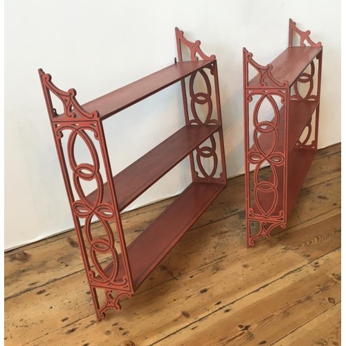 77 - PAIR OF RED PAINTED HANGING WALL SHELVES20TH CENTURYwith fret pierced sides67cm high, 69.5cm wide... 