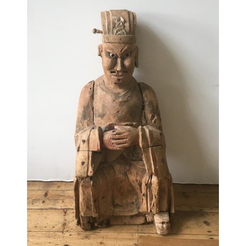 112 - A CHINESE CARVED WOOD FIGURE OF AN OFFICIAL, LATE MING, EARL QING, with traces of old lacquer and pa... 