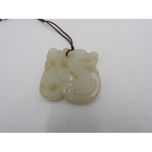 119 - CHINESE WHITE JADE 'DRAGON' PENDANTLATE QING / REPUBLIC PERIOD4cm wide