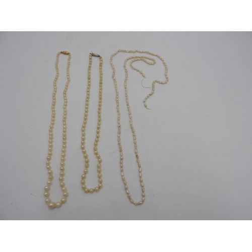 598 - TWO GRADUATED PEARL NECKLACES WITH 9ct GOLD CLASPS, and a string of fresh water pearls