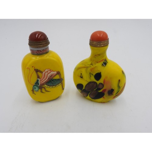 609 - TWO 20th CENTURY YELLOW GLASS SNUFF BOTTLES, one with embossed grasshopper decoration, and the other... 