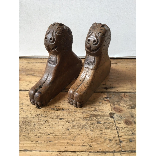 616 - A PAIR OF CARVED OAK LEADED LION FIGURES, from a monk's bench, 18th century, possibly earlier19 x 22... 