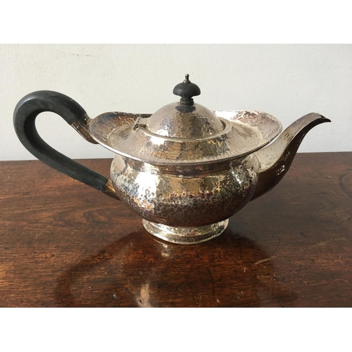 618 - A HALLMARK SILVER HAMMERED TEA POT, Birmingham, 1926, 21oz (inc.handles), 15cm high