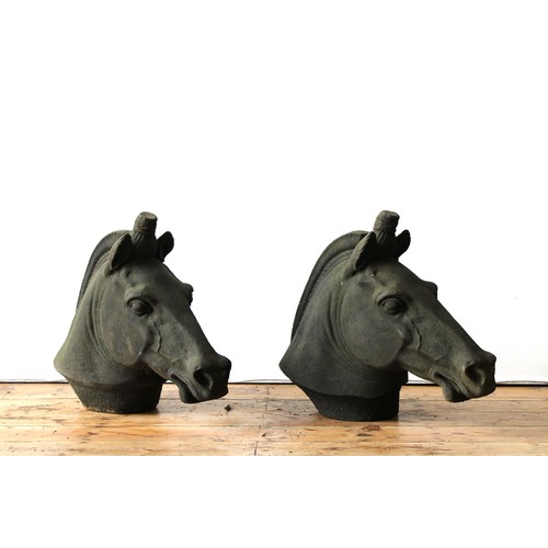 98 - A PAIR OF RECONSTITUTED STONE HORSE'S HEAD PILLAR TOP ORNAMENTS, 54cm high x 66cm long