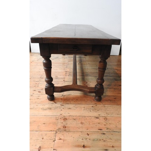 19 - A 19TH CENTURY FRENCH OAK FARMHOUSE TABLE ON TURNED LEGS, on shaped stretcher bar support with singl... 