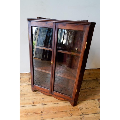 24 - A STAINED PINE 2-DOOR GLAZED WALL MOUNTED CORNER DISPLAY CABINET, 85 x 66cms