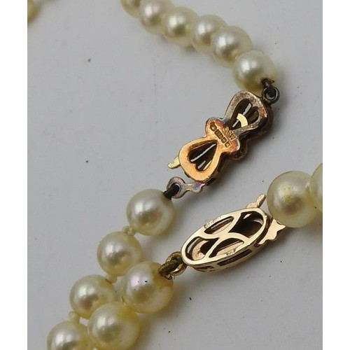 515 - TWO CULTURED PEARL NECKLACES, BOTH WITH 9CT GOLD CLASPS