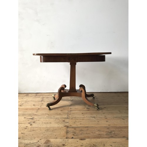 28 - A EARLY 19th CENTURY CROSSBANDED MAHOGANY CARD TABLE, on central tapered pedestal with carved acanth... 