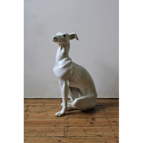 105 - A LARGE CREAM GLAZED TERRACOTTA FIGURE OF SEATED DOG, 88cm high