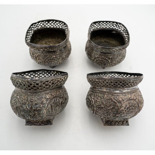 481 - A SET OF FOUR INDIAN SILVERED BOWLS, with embossed foliate decoration and pierced fret work rims, 8c... 