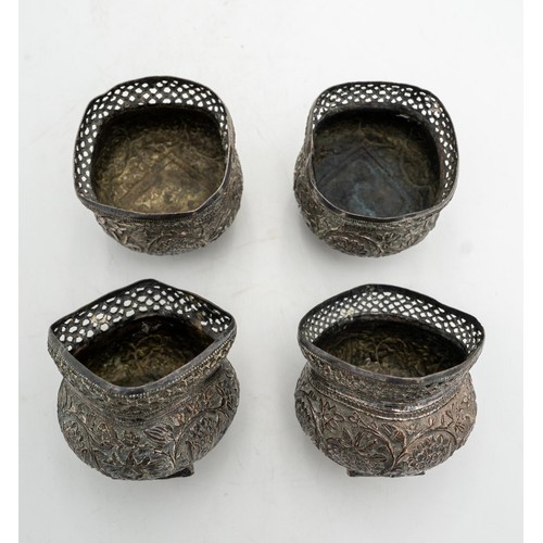 481 - A SET OF FOUR INDIAN SILVERED BOWLS, with embossed foliate decoration and pierced fret work rims, 8c... 