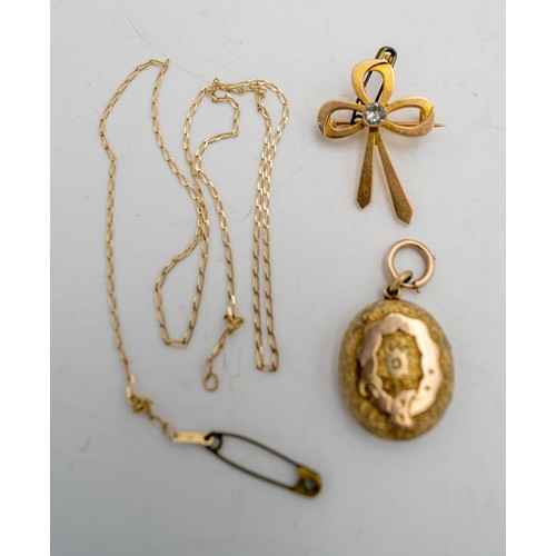 528 - A 9CT GOLD BOW BROOCH AND A GOLD LOCKET ON CHAIN, total weight 15g