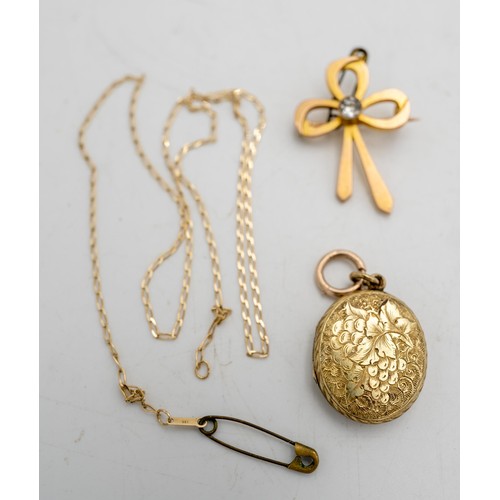 528 - A 9CT GOLD BOW BROOCH AND A GOLD LOCKET ON CHAIN, total weight 15g