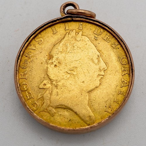 500 - A GEORGIAN GOLD HALF GUINEA COIN, DATED 1787, in bevelled fob mount