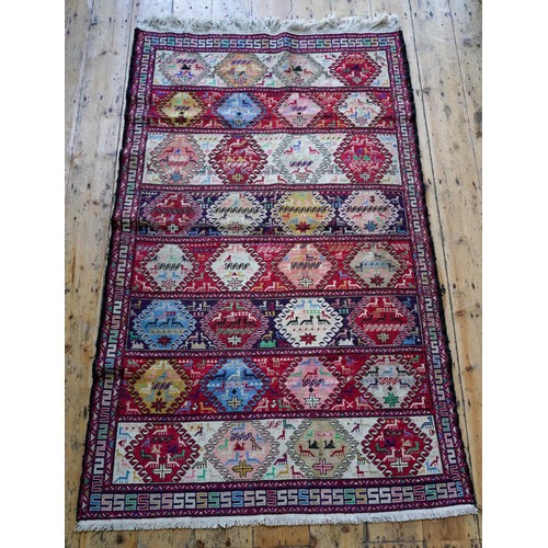 96 - A TURKISH BORDER PATTERN ANIMAL DECORATED RUG, 184 x 116cms