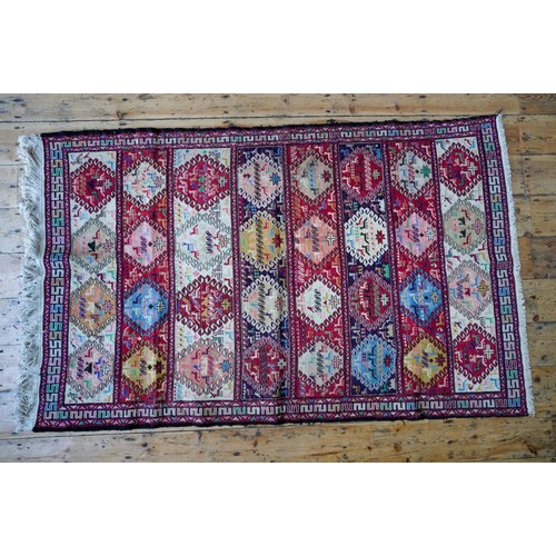 96 - A TURKISH BORDER PATTERN ANIMAL DECORATED RUG, 184 x 116cms