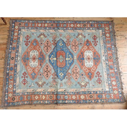 97 - TURKISH BORDER PATTERN GEOMETRIC DESIGN RUG, red and fawn on a blue ground, 210 x 164cms