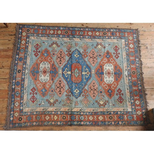 97 - TURKISH BORDER PATTERN GEOMETRIC DESIGN RUG, red and fawn on a blue ground, 210 x 164cms