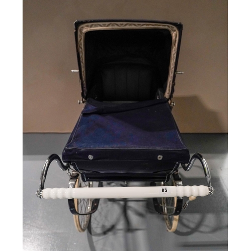 6 - A WILSON 'COACH BUILT' PRAM WITH DARK BLUE LIVERY, curved coach springs and pull-over fabric hood an... 