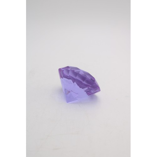 243 - A ROSENTHAL AMETHYST COLOURED GLASS 'PRINCESS CUT' PAPER WEIGHT, the Rosenthal mark etched onto base