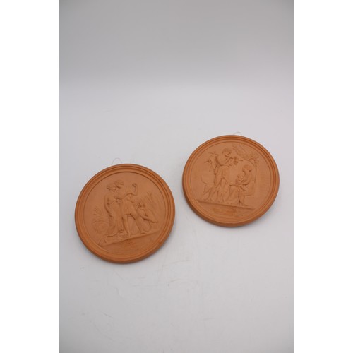 252 - A PAIR OF DANISH CIRCULAR TERRACOTTA PLAQUES EMBOSSED WITH ROMAN SCENES, depicting hunter and family... 