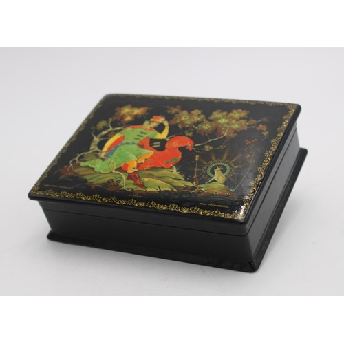 258 - A USSR 20th CENTURY HAND PAINTED PAPIER MACHE LAQUERED TRINKET BOX, decorated with folk lore scene, ... 