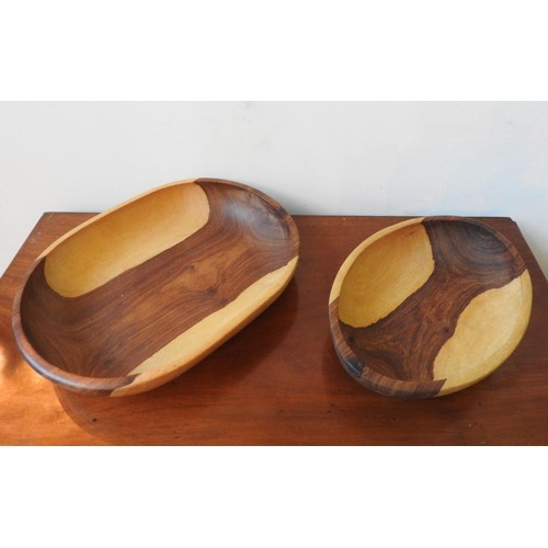 263 - TWO CARVED INDIGENOUS WOODEN BOWLS, one obong and one oval, 42 x 32cm and smaller