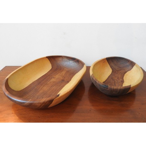 263 - TWO CARVED INDIGENOUS WOODEN BOWLS, one obong and one oval, 42 x 32cm and smaller