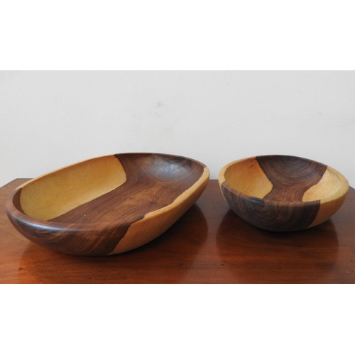 263 - TWO CARVED INDIGENOUS WOODEN BOWLS, one obong and one oval, 42 x 32cm and smaller