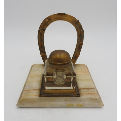 267 - A NOVELTY JOCKEY'S INKWELL STAND, comprising of a horseshoe shaped pen rack and an inkwell with a li... 