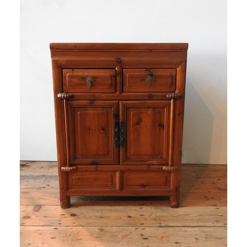 21 - AN ORIENTAL STYLE HARDWOOD TWO DOOR CUPBOARD, with two drawers, 86 x 64 x 50cm