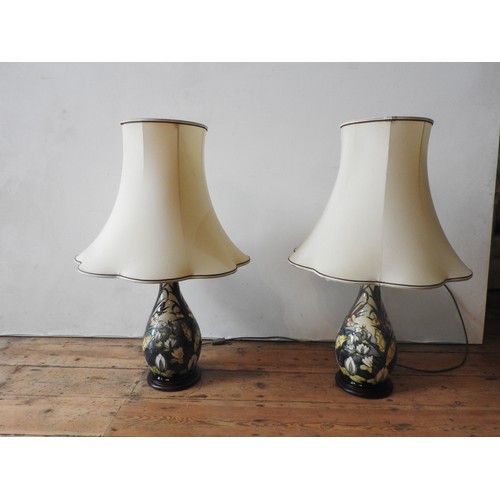 270 - A PAIR OF CREAM GLAZED MOORCROFT TABLE LAMPS, decorated with lillies and bull rushes, both lamps wit... 