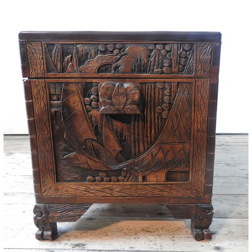 34 - AN ORNATE CARVED CAMPHORWOOD BLANKET CHEST , with two carved handles and claw feet,  62 x 98 x 54 cm