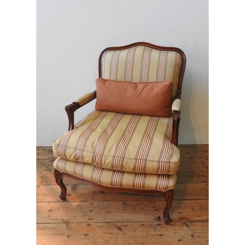 45 - A WADE UPHOLSTERY 'RIMINI' ARMCHAIR AND FOOTSTOOL, both upholstered in gold and burgundy pinstripe p... 