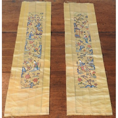 228 - TWO GOLD COLOURED EMBROIDERED ORIENTAL SILK PANELS depicting geishas in pleasure garden, 70 x 19 cm ... 