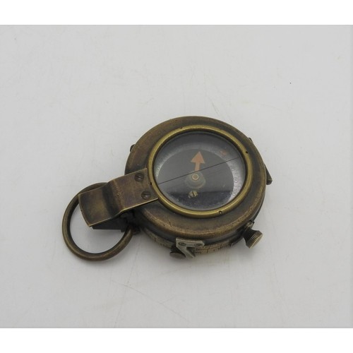 236 - A BRASS FIRST WORLD WAR COMPASS, inscribed on the reverse F-L, No.121057, 1918, 5 cm dia