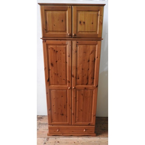 55 - A PINE PANELLED WARDROBE, A PINE WARDROBE WITH TOP LOCKER A ND A PINE CHEST OF SIX DRAWERS, and a pa... 