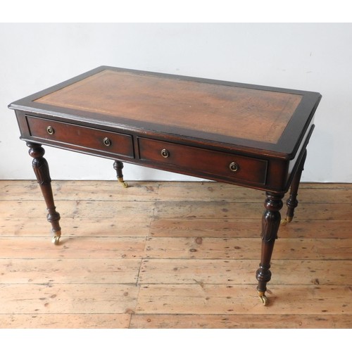 57 - A 20TH CENTURY MAHOGANY REGENCY STYLE LIBRARY TABLE, with leather top, the legs carved with tulip de... 